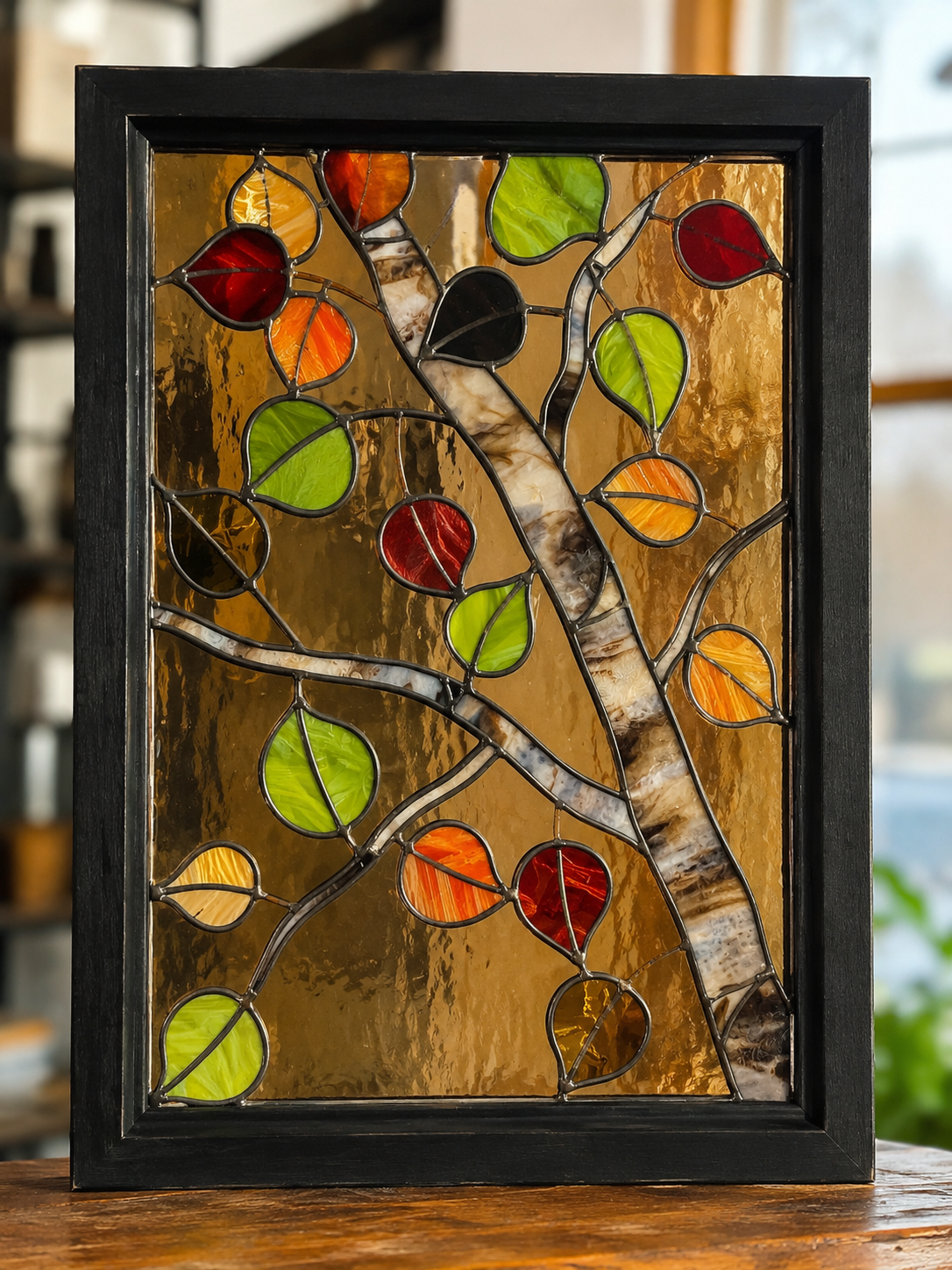 Advanced multi-panel stained glass workshop project on a studio worktable